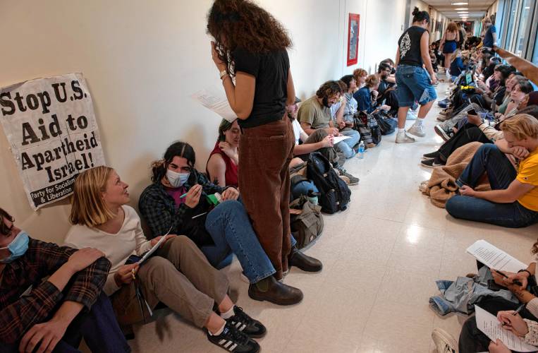 UMass students gather outside the chancellor’s office in the Whitmore Administration Building Wednesday to demand that the university cut ties with weapons manufacturers and condemn Israeli actions in Gaza. UMass Police arrested 56 students and one faculty member after the building closed at 6 p.m. 