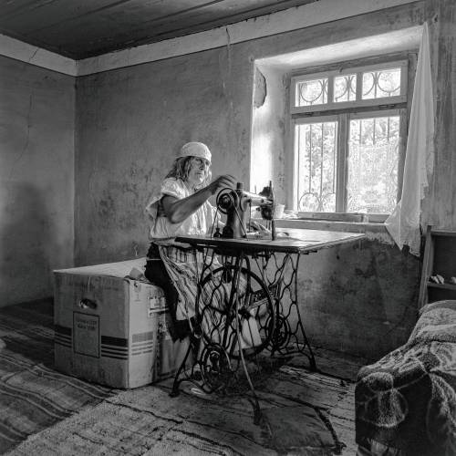 Marije Paldoci works with an old sewing machine in her home in Gajtan, Albania in this 1994 image.
