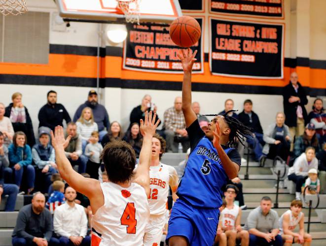 Granby’s Gavier Fernandez (5) puts up a shot against South Hadley in the second quarter Wednesday night in South Hadley.