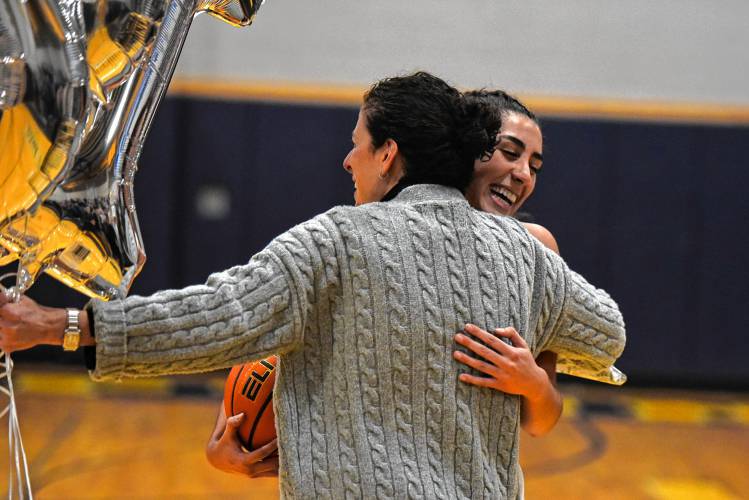 Northampton’s Ava Azzaro hugs her mother Margaret-Ann after scoring the 1,000th point of her career against Wahconah on Monday night in Northampton.