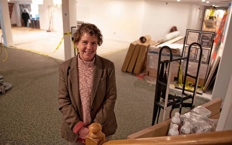 Maureen O’Toole, the executive director of Loomis Village in South Hadley in the lobby with renovations in the background.
