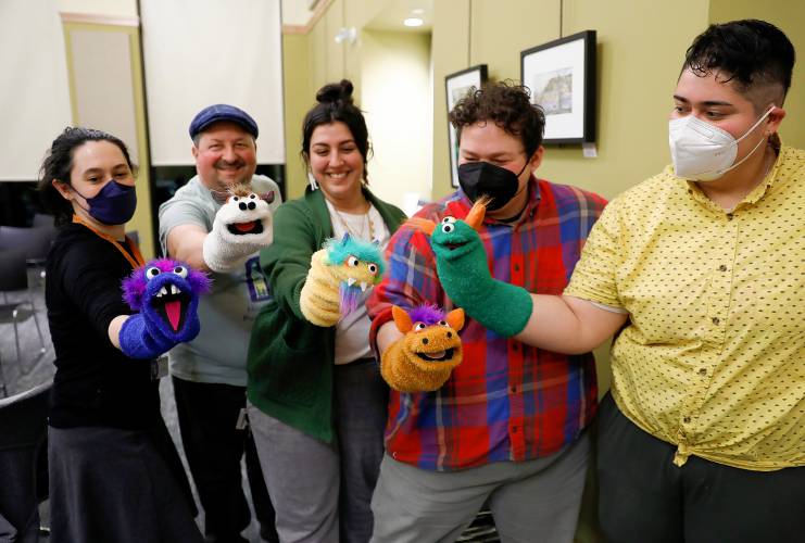 The finished puppets made during a deluxe sock puppet class by Homeslice Puppetry on Thursday night at the South Hadley Public Library. From left are librarian Sarah Courtney, Eric Weiss of Homeslice Puppetry, Samantha Morin, Evan Delano and Ana Ascencio.
