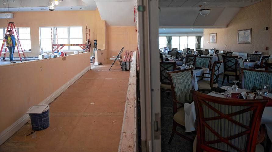 A wall divides the dining area in Loomis Village in South Hadley where renovations are happening in sections.
