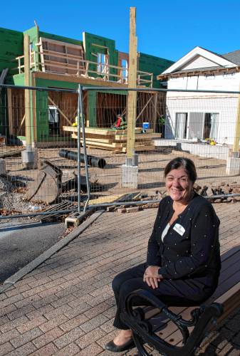 Margaret Mantoni, chief executive officer, in front of the addition in the construction phase at the Applewood Independent Living community in Amherst, which will include 9 new apartments and a meeting space.