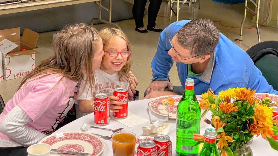  Tom and Lulu Rozene, together with their 7-year-old daughter Ali, enjoy a Thanksgiving meal together at Edwards Church in Northampton, served by volunteers at Manna Soup Kitchen. The organization has served Thanksgiving meals to families for more than 35 years.