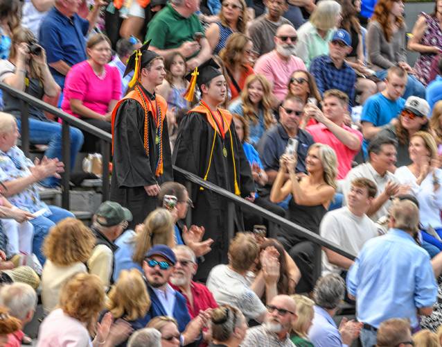 South Hadley High School Class of 2024 valedictorian Caleb Cox, left, and salutatorian Jaden Yeung descend the amphitheater steps during their graduation ceremony at Mount Holyoke College on Friday.