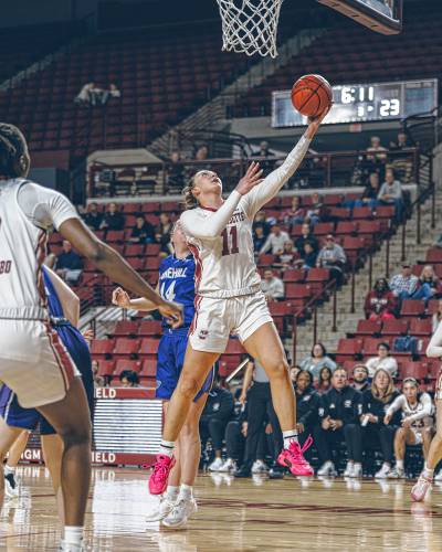 UMass' Megan Olbrys goes in for a layup against Stonehill on Thursday during the opening round of the Women's NIT at the Mullins Center. 