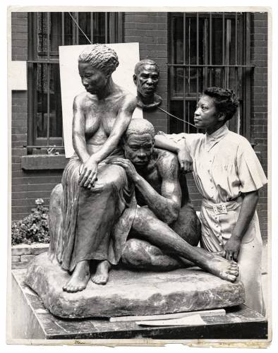 The legacy of trailblazing sculptor Augusta Savage, seen here in 1938 with her work “Realization,” will be celebrated at UMass.