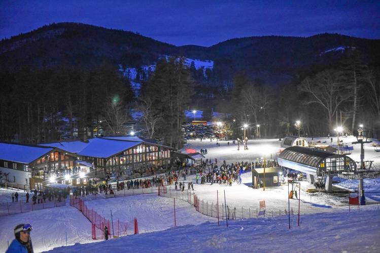 Racers queue up to take the detachable lift to the top during an evening high school ski meet at Berkshire East Mountain Resort recently.