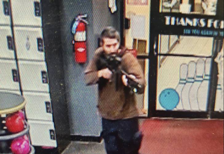In this image taken from video released by the Androscoggin County Sheriff’s Office, an unidentified gunman points a gun while entering Sparetime Recreation in Lewiston, Maine, on Wednesday, Oct. 25, 2023. Maine State Police ordered residents in the state’s second-largest city to shelter in place Wednesday night as the suspect remains at large.