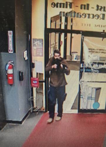 In this image taken from video released by the Androscoggin County Sheriff’s Office, an unidentified gunman points a gun while entering Sparetime Recreation in Lewiston, Maine, on Wednesday, Oct. 25, 2023. Maine State Police ordered residents in the state’s second-largest city to shelter in place Wednesday night as the suspect remains at large.