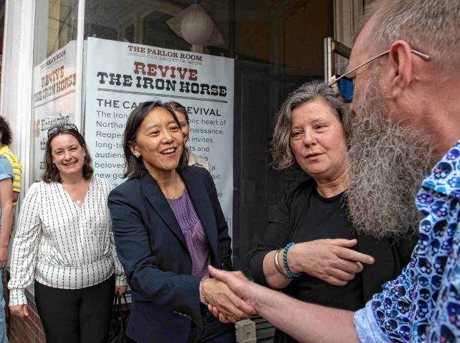 Yvonne Hao, secretary of the state’s Executive Office of Economic Development, shakes hands with Steve Sanderson, event producer with the Northampton Arts Council, outside the Iron Horse Music Hall  during a tour to Northampton Monday afternoon. 