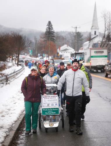 Radio personality Christopher “Monte” Belmonte, center, walks down Route 116 in Sunderland with fellow participants of the 2018 Monte’s March.