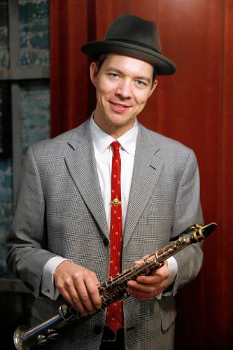 Clarinetist and saxophonist Evan Arntzen at Gombo Nola Kitchen & Oyster Bar, holding a 100-year-old soprano saxophone once owned by the storied clarinetist George Lewis, who was born in New Orleans in 1900.