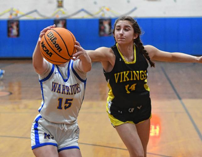 Mohawk Trail’s Rachel Pease, left, and Smith Voc’s Sofia Zina vie for a rebound in Buckland on Thursday night.