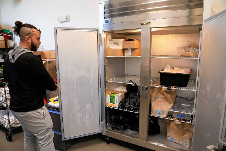 Emmanuel Reyes shows the part of the new Holyoke Community Cupboard food pantry space Thursday at the HCC MGM Culinary Arts Institute on Race Street in Holyoke.