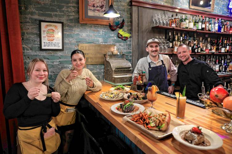 Owner and chef John Piskor, from right, poses for a photo with his staff Sam Baluzy, Nyah Forth and Kyah Woofenden at Gombo Nola Kitchen & Oyster Bar on Main Street in Northampton.