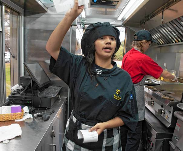 Amarylis Lopez, a junior in the culinary program at Smith Vocational and Agricultural High School, asks about an order on opening day of the program’s new food truck. The truck will be open in front of the school Friday morning and for Friday night’s fall festival. 